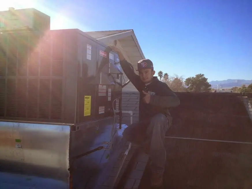 HVAC technician performing HVAC Inspection on a rooftop unit in Highland Heights